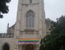 A church in Washington DC proudly displays the Gay Flag with the slogan "All are welcome".