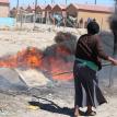 Boystown resident burning tyres. Photo by Mihle Pike.