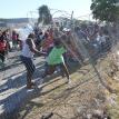 Angry parents taking down the school fence. Photo by Mihle Pike.