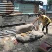 A woman shows her soiled couch as a result of floods. Photo Tariro Washinyira. A woman shows her soiled couch as a result of floods. Photo Tariro Washinyira.