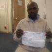 Taurai Hativagone showing the receipts of the money he paid to the funeral service company. Photo by Tariro Washinyira.