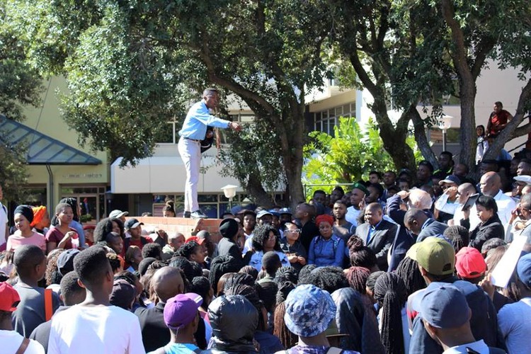 Photo of man talking to crowd