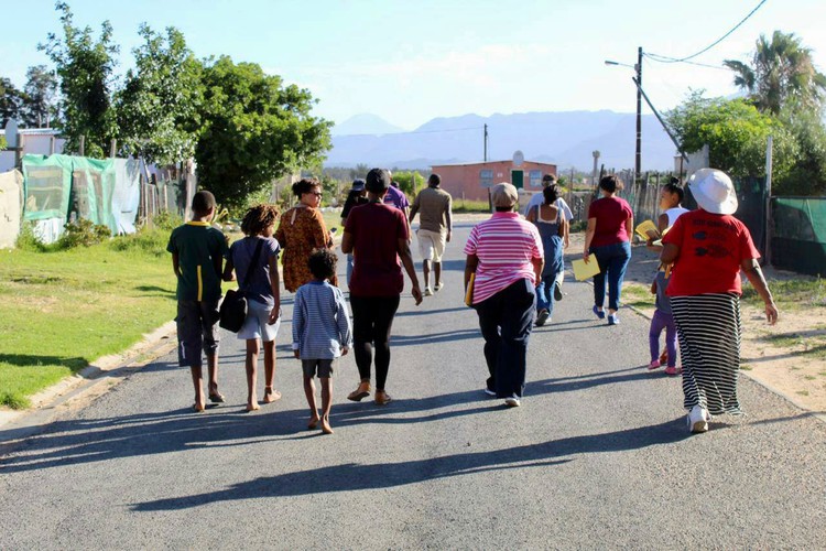 Photo of a group of people walking in a street