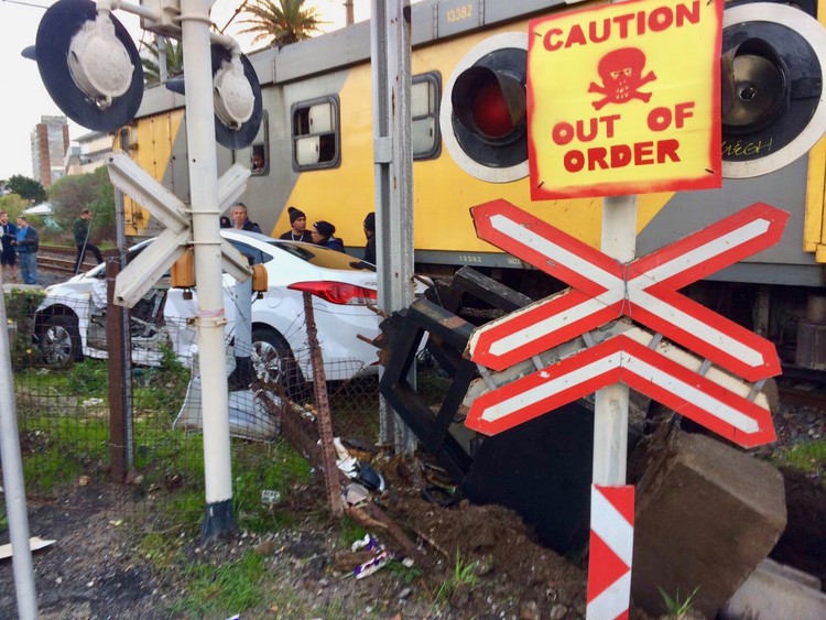 Photo of a train and a smashed car