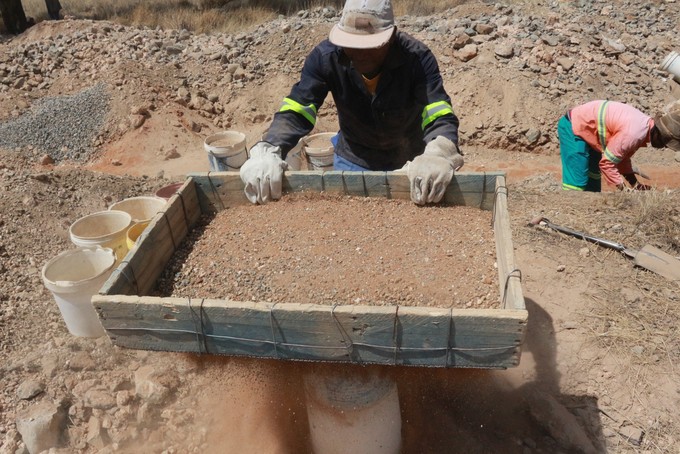 Photo of men looking for diamonds