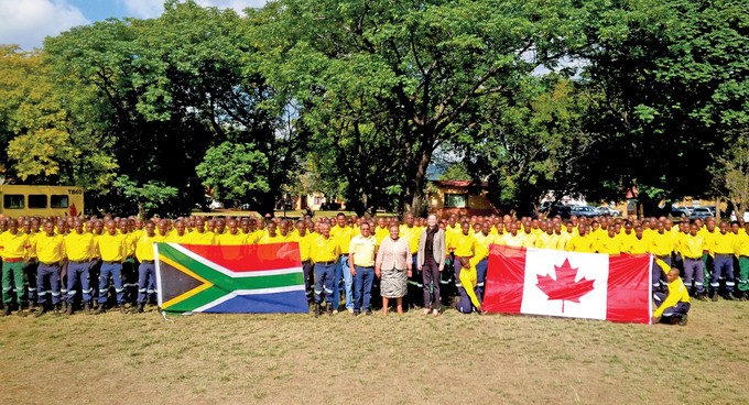 Photo of firefighters with South African and Canadian flags
