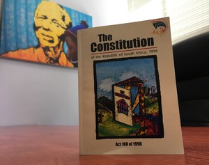 Photo of Constitution against background of Mandela wallart