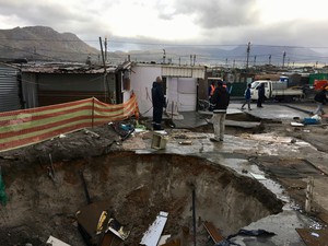 Photo of a big hole and shacks