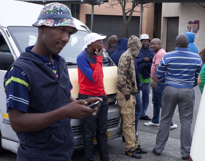 Photo of men near taxi