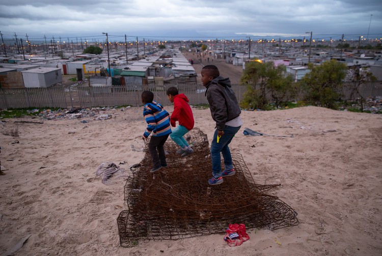 Photo of children playing on a hill just outside Blikkiesdorp, a temporary relocation area (TRA) found about 25km\'s from Cape Town’s city centre