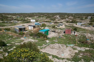 Photo of a shack on open land