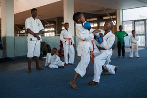 Photo of a young boy practicing karate at a dojo in Khayelitsha