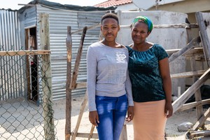 Lerato Ruth Sihlangu and her Auntie, Noncedo Mlilwana outside their home in Mfuleni. Sihlangu matriculated amongst the top of her year at Masiyile High School in Khayelitsha. Photo: Ashraf Hendricks
