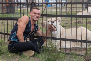 Quinton Louw poses with Diamond, a 3 year old lioness. Louw started out as a handler, but is now performing with the animals. He says that being on stage with them “feels amazing” .