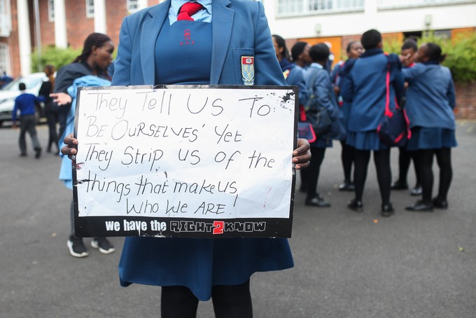 Photo of schoolgirl holding placard