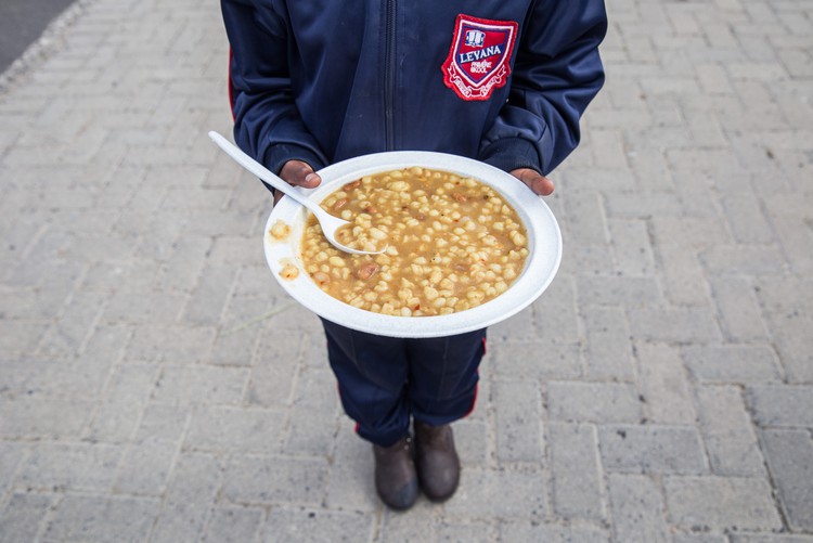 Photo of a child holding a plate of food