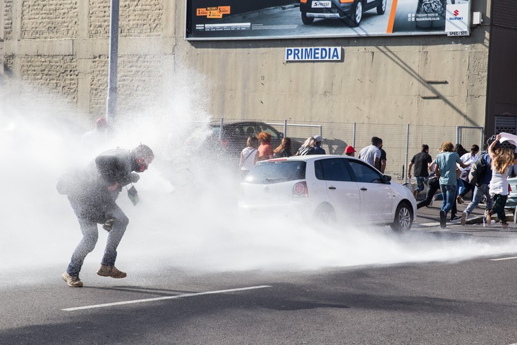 Photo of protesters and a water canon