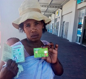 Photo of a woman with a plastic card and ID