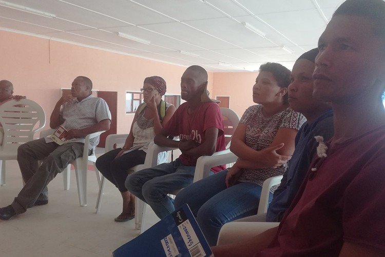 Photo of people sitting in a semi circle