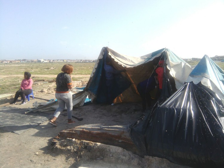 Photo of people living in makeshift tents