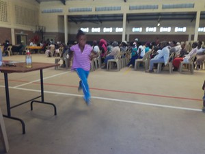 Photo of people in a hall and a child running