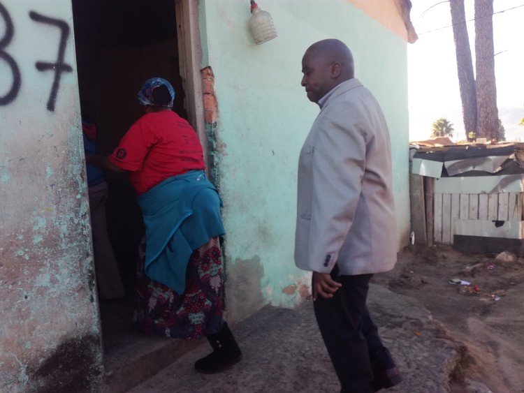 Photo of woman showing man  a house