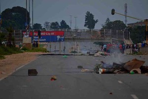 Photo of road strewn with rubbish after protest