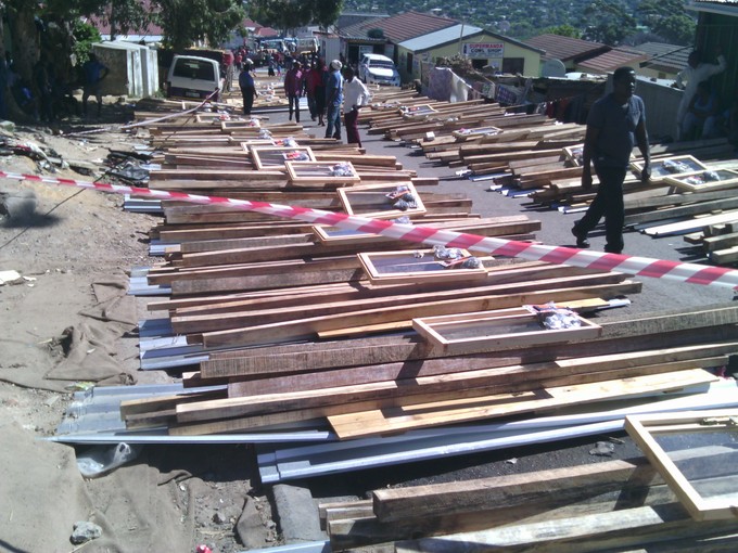 Photo of housing materials stacked along the road