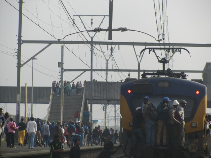 Photo of people hanging onto the back of a train
