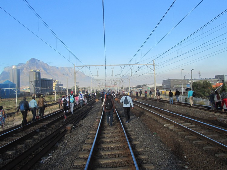 Photo of people walking on a railway line