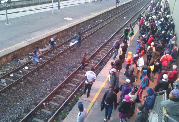 Photo of people jumping onto railway tracks
