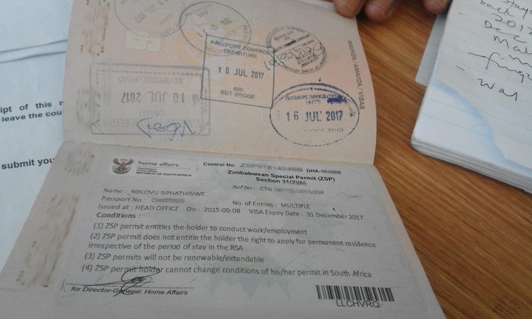 Photo of a Zimbabwean passport with a permit
