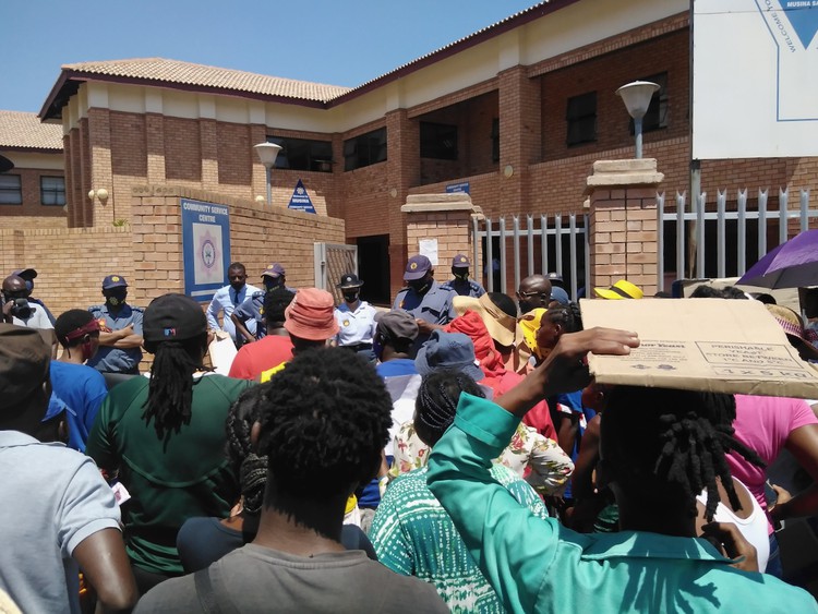 Photo of demonstrators at a police station