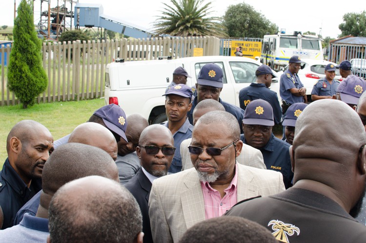 Photo of Gwede Mantashe surrounded by police