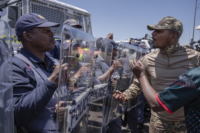 Members of the anti-immigration vigilante group known as Operation Dudula are confronted by police during a protest staged by the group during the G20 leaders summit near Nasrec in Johannesburg, South Africa.