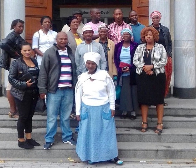 Photo of a group of people on the steps of the High Court