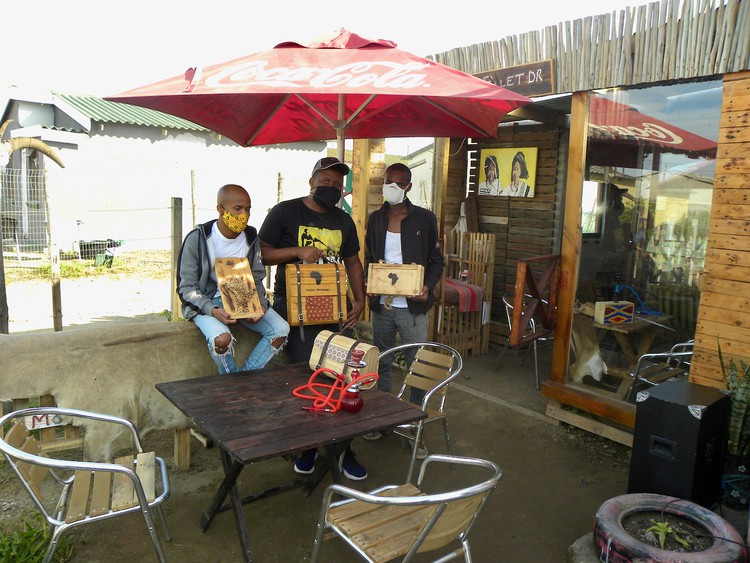 Photo of three men in a yard