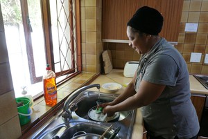 Zanele Tasana spends her working day cleaning at a lodge in Observatory. Photo: Kristine Liao
