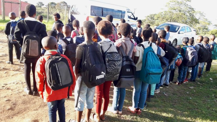 Photo of a group of children at the roadside