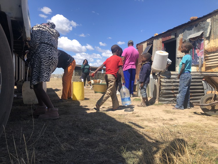 Photo of people fetching water 