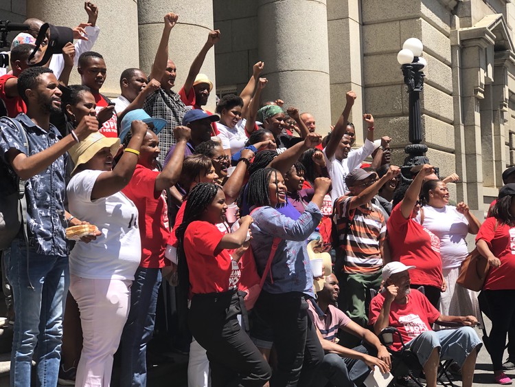 Photo of people on steps of court
