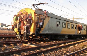 Photo of people clinging onto train