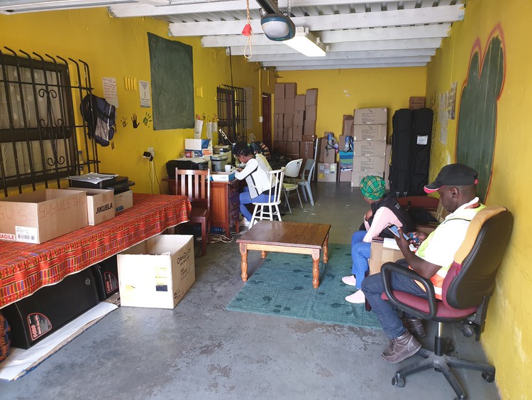 Photo of people at desks in a garage