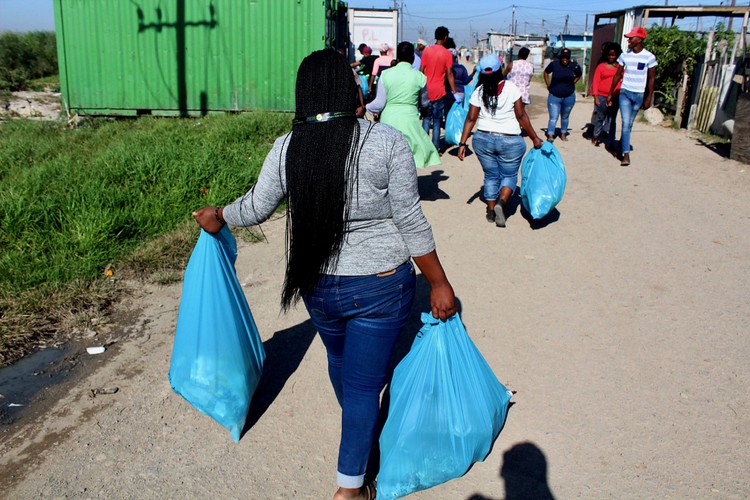 Photo of people carrying refuse bags