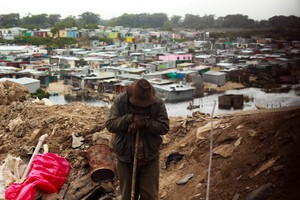 Photo of man with township in background