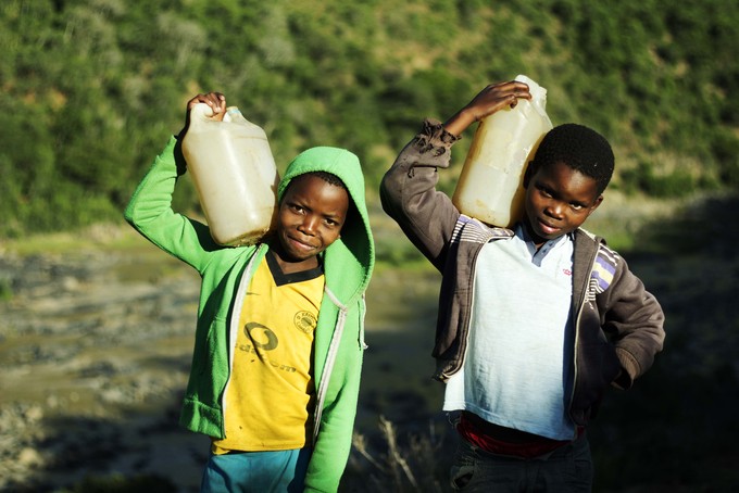 Photo of two boys carrying water