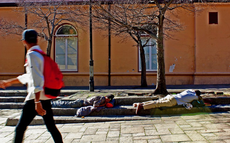 Photo of people sleeping on the pavement