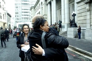 Photo of woman hugging man outside court