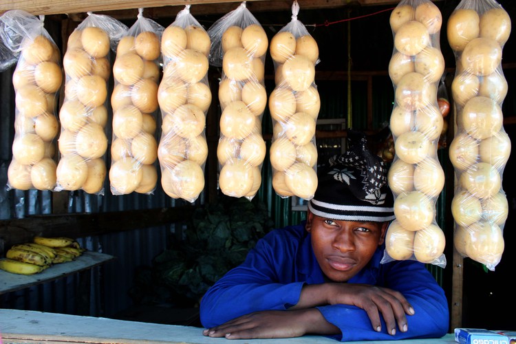 Thabiso Tshepe sells fruit and vegetables at his brother’s stand.