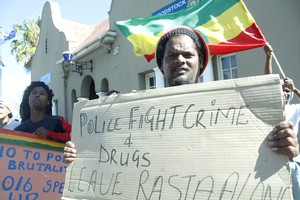 Photo of a Rastafarian man protesting outside Woodstock Police Station.